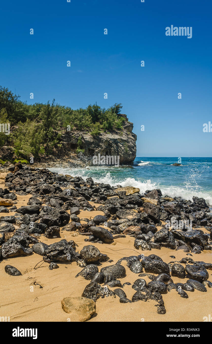 A cliff & rocks along Shipwreck Beach in Kauai, Hawaii, USA Stock Photo