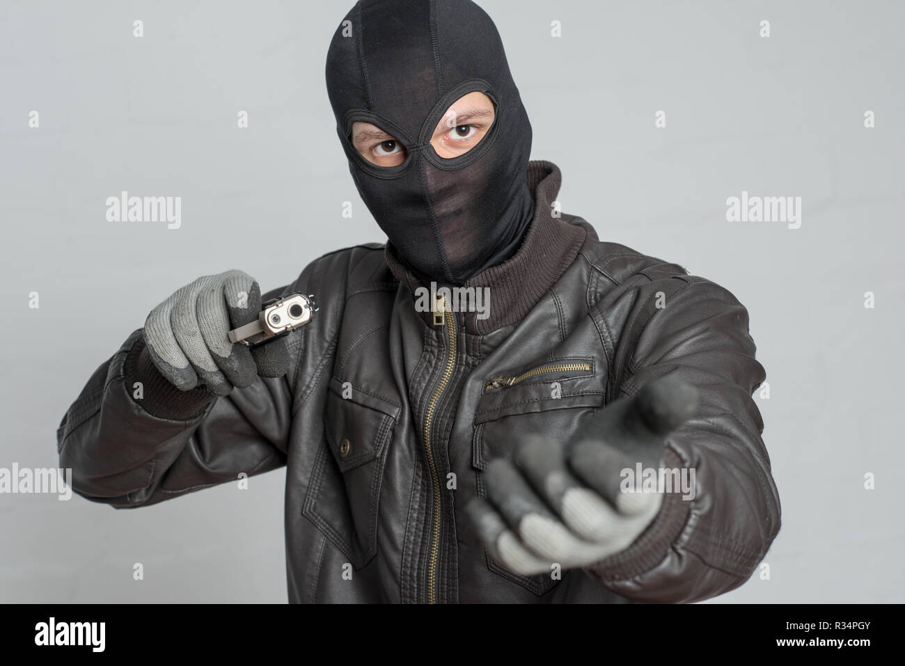 burglar threatening with weapon Stock Photo