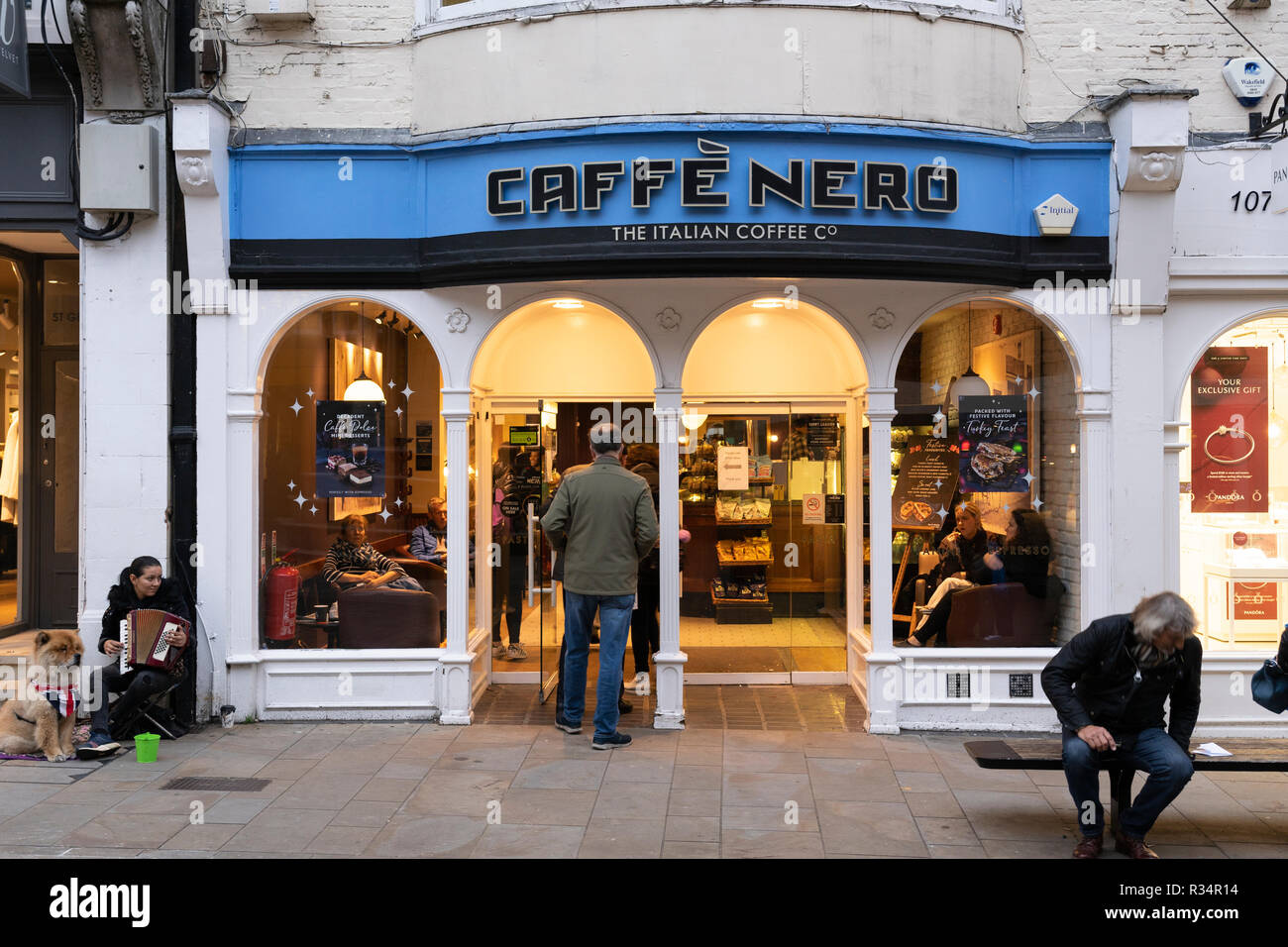 A man entering a Cafe Nero coffee shop on Winchester High Street, England Stock Photo