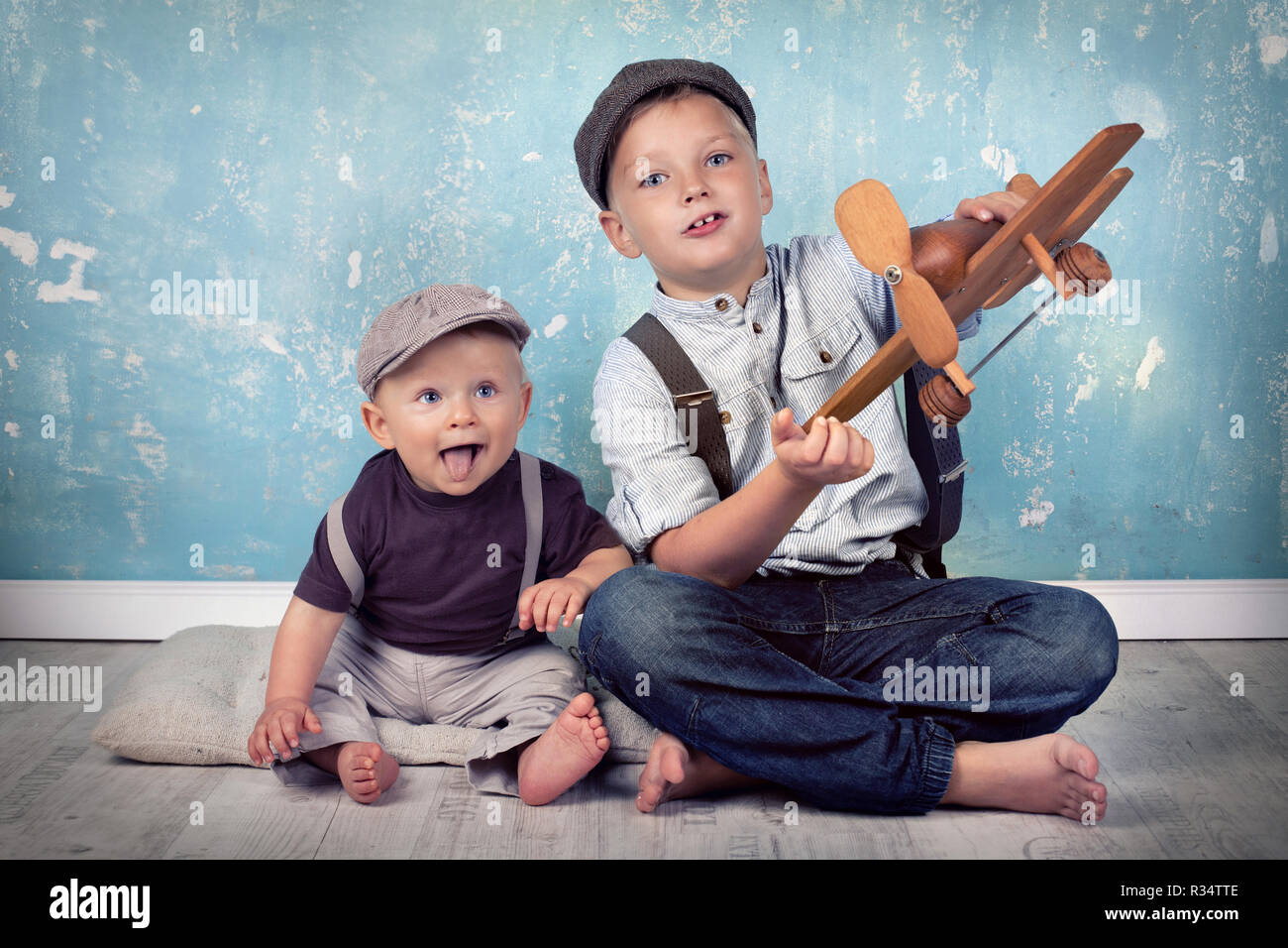 two brothers playing with wooden flyer Stock Photo