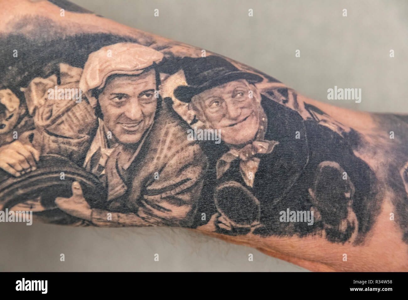 England, London, Wapping, Tobacco Dock, London Tattoo Convention, Tattooed Male showing Characters from The English TV show Steptoe and Son Stock Photo