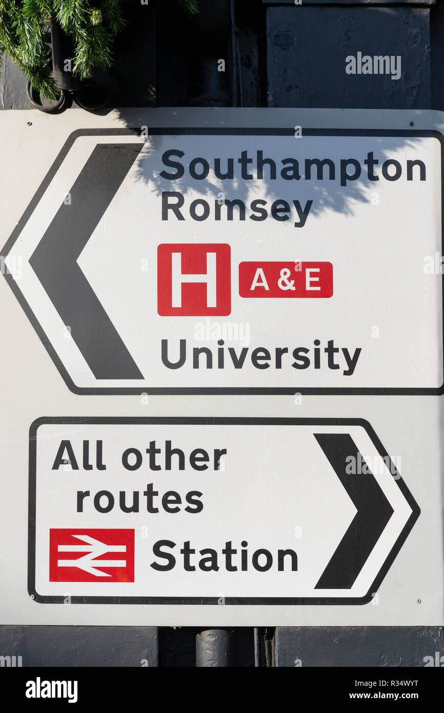 A Class 2 (high intensity) retroflective road sign in England with directions to a train station, all other routes, Southampton and Romsey Stock Photo