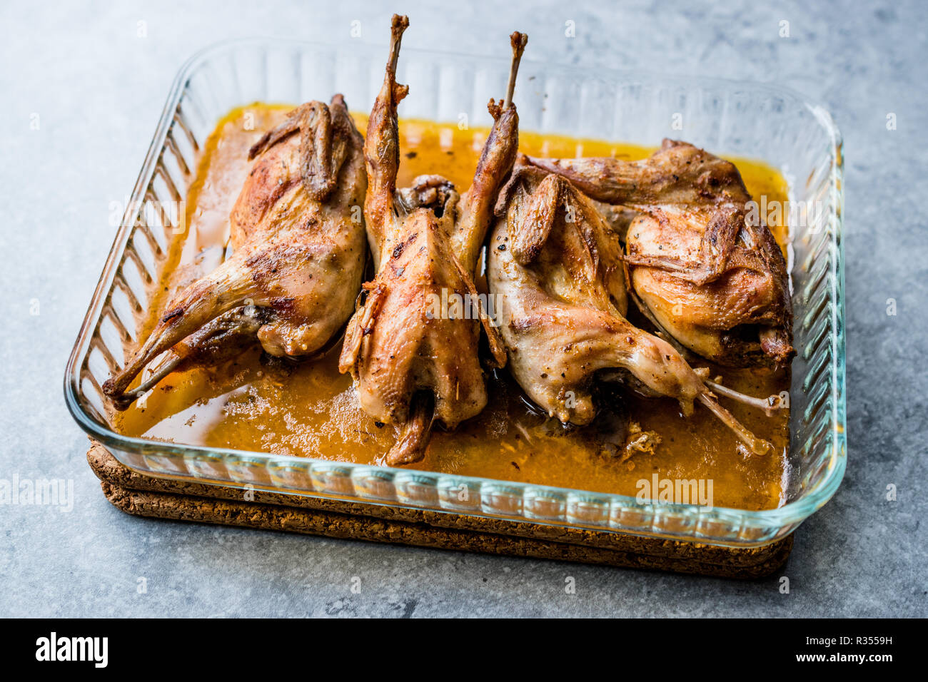 Roasted Crispy Quail Meat in Glass Bowl / Fried Small Chickens. Organic Food. Stock Photo