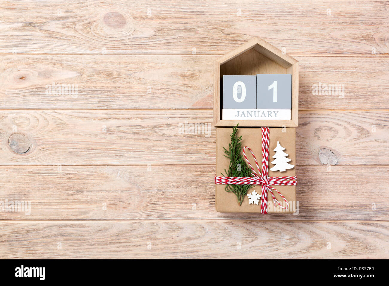 Box With January Calendar with date 1 january and gift boxes on color background ...