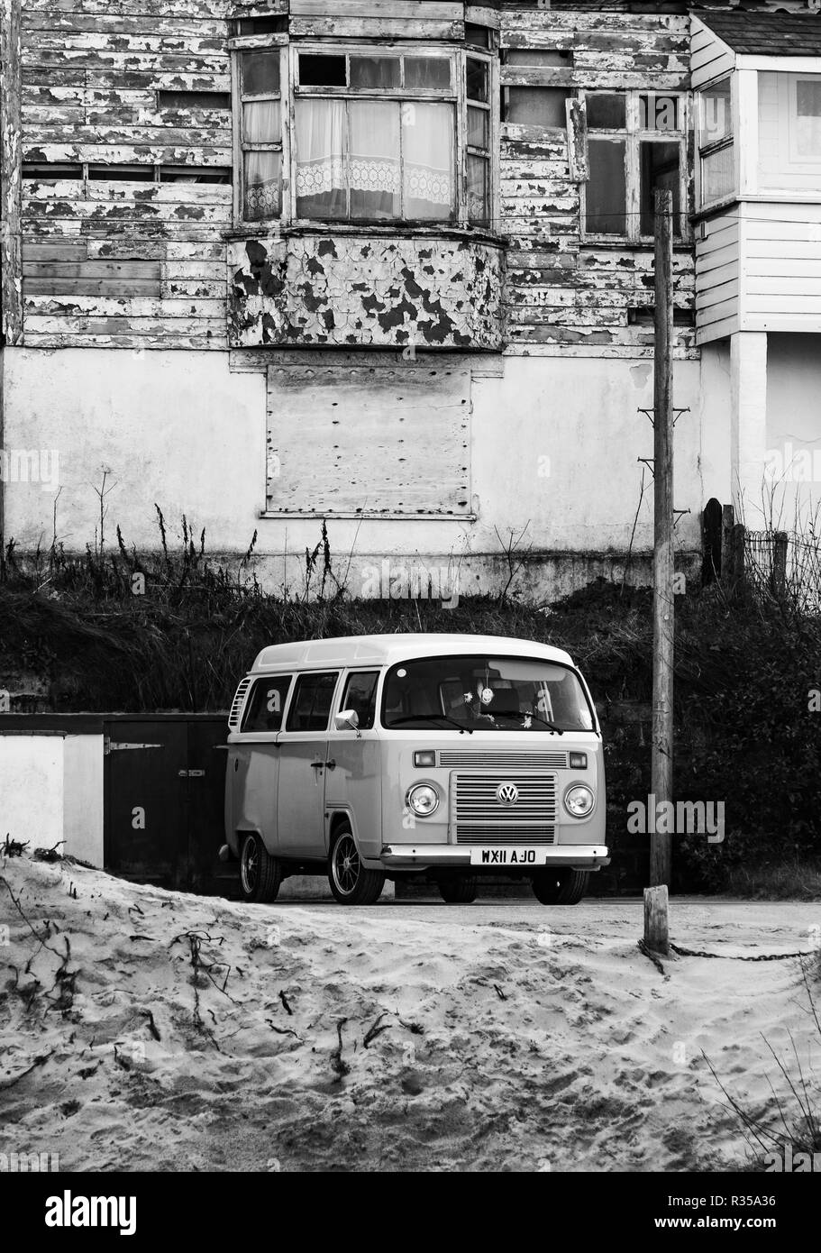 Vintage VW camper parked up in front of an old bay windowed, two storey ...