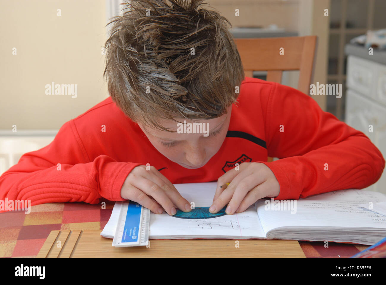 Nine Year Old Boy doing his homework Stock Photo