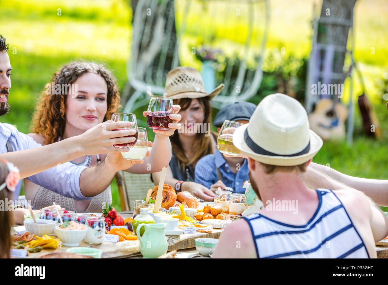 Group of young people sitting at a brunch in the countryside Stock Photo