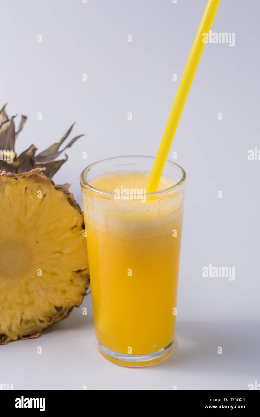 Front view the glass of pineapple juice a part of pineapple fruit over ...