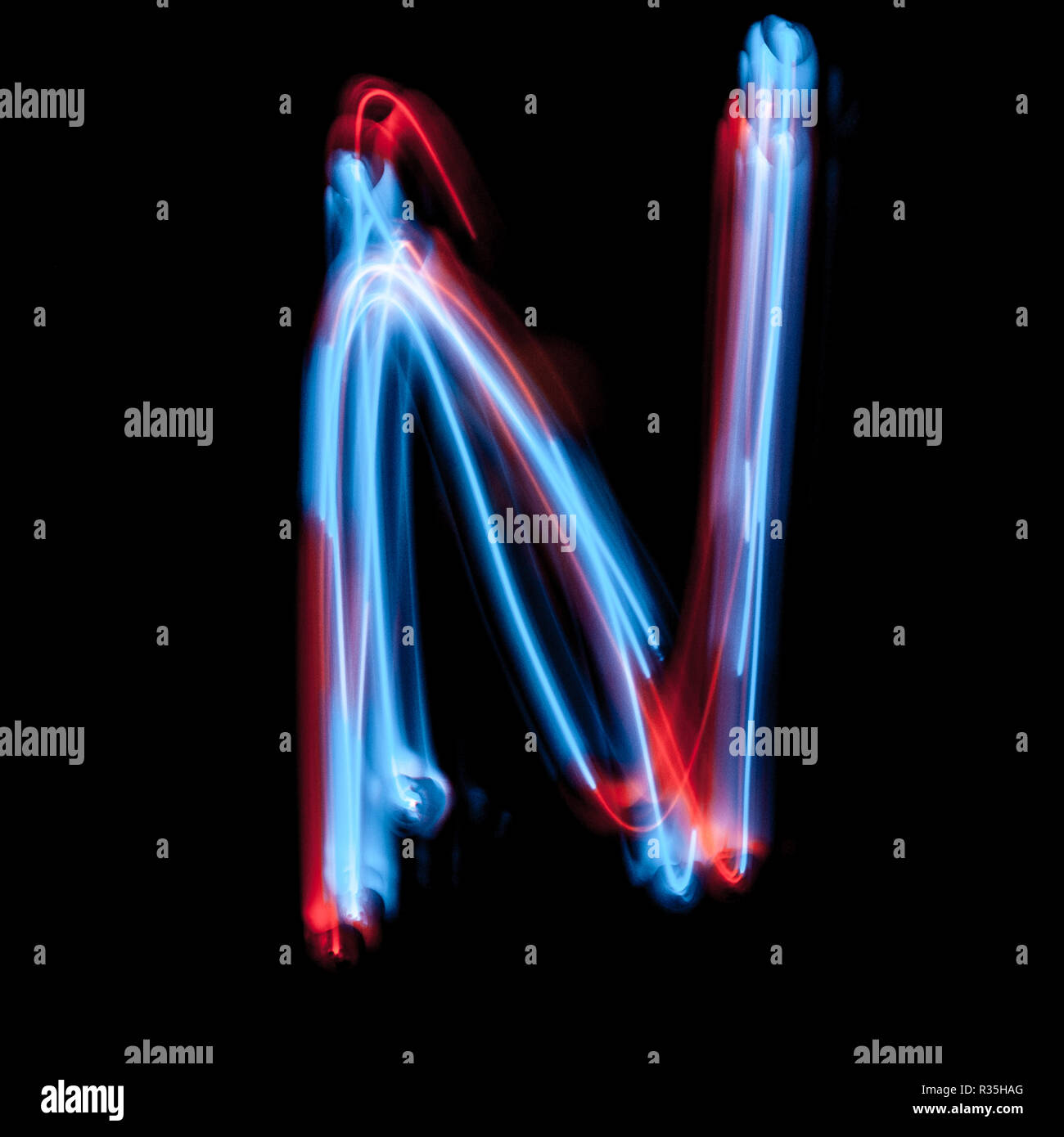 Letter N of the alphabet made from neon sign. The blue light image, long  exposure with colored fairy lights, against a black background Stock Photo  - Alamy