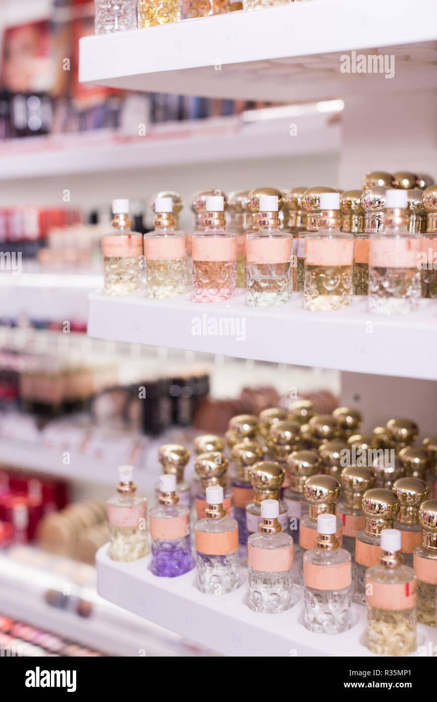Bottles of perfume for sale on shelves of cosmetic shop Stock Photo Alamy