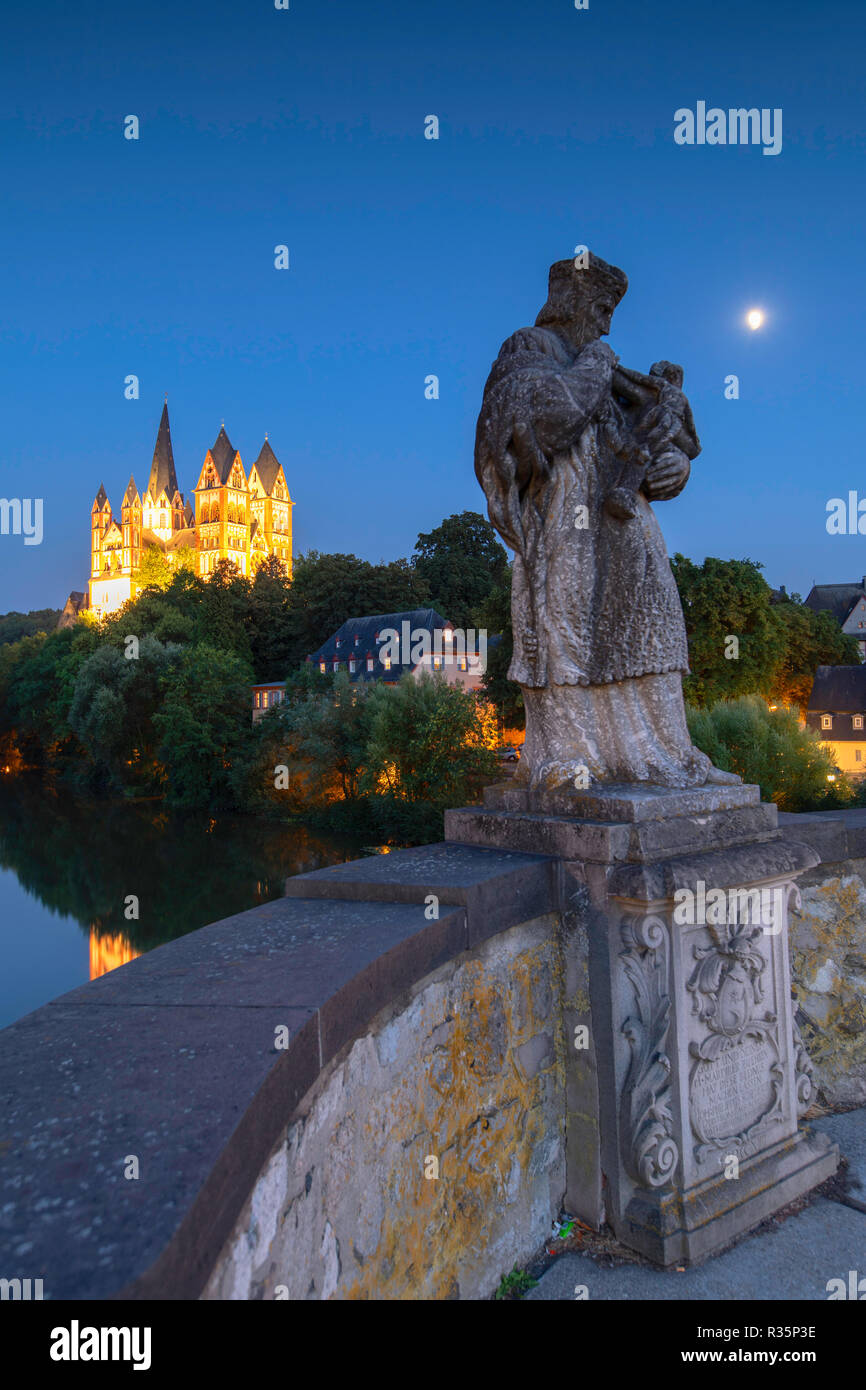 Statue on Old Lahn Bridge (Alte Lahnbrucke), Cathedral (Dom) and River Lahn at dusk, Limburg, Hesse, Germany Stock Photo