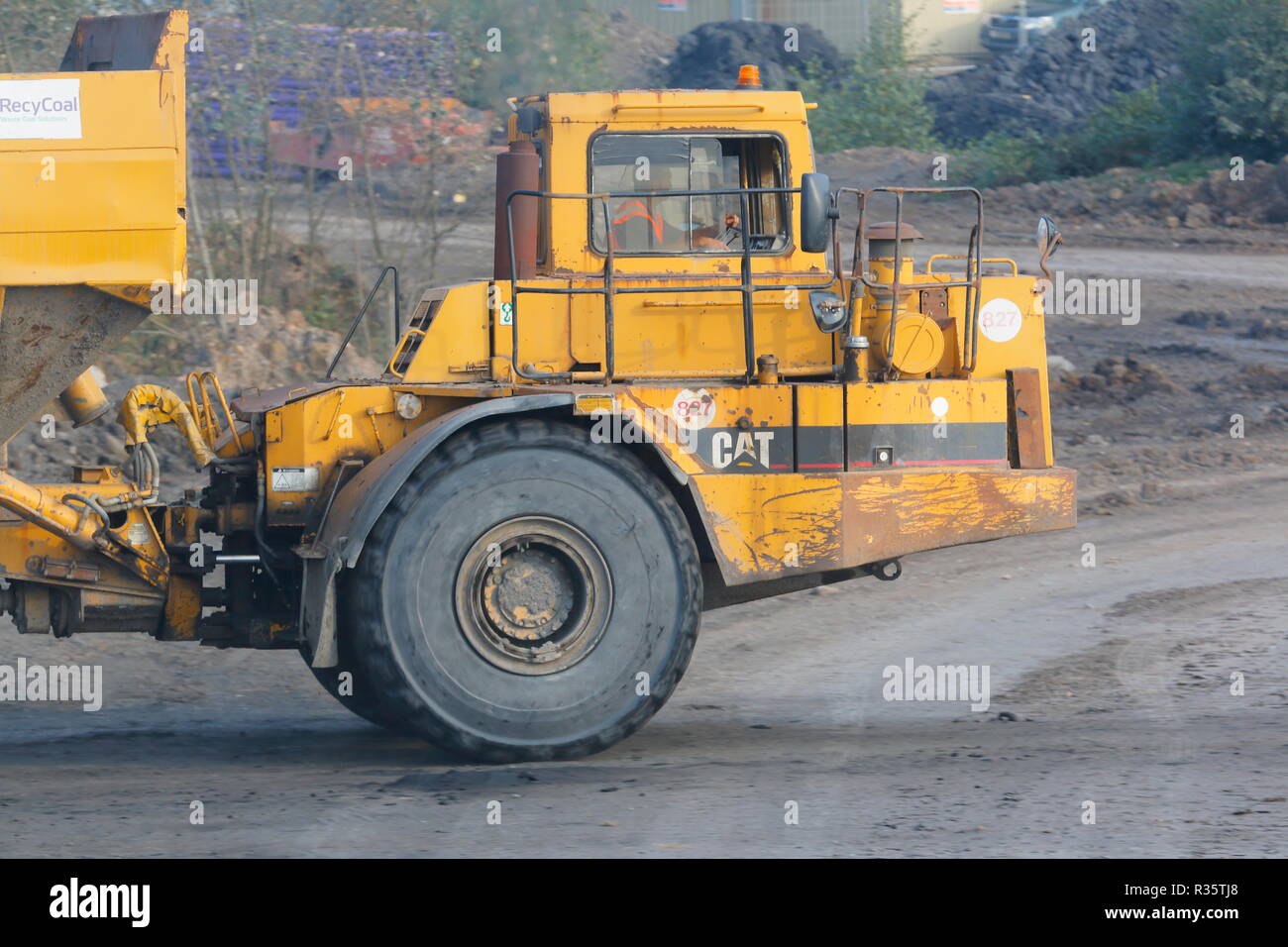 A Caterpillar 400D at work on the old Recycoal Coal Recycling Plant in Rossington,Doncaster which has now been demolished to make way for new houses. Stock Photo