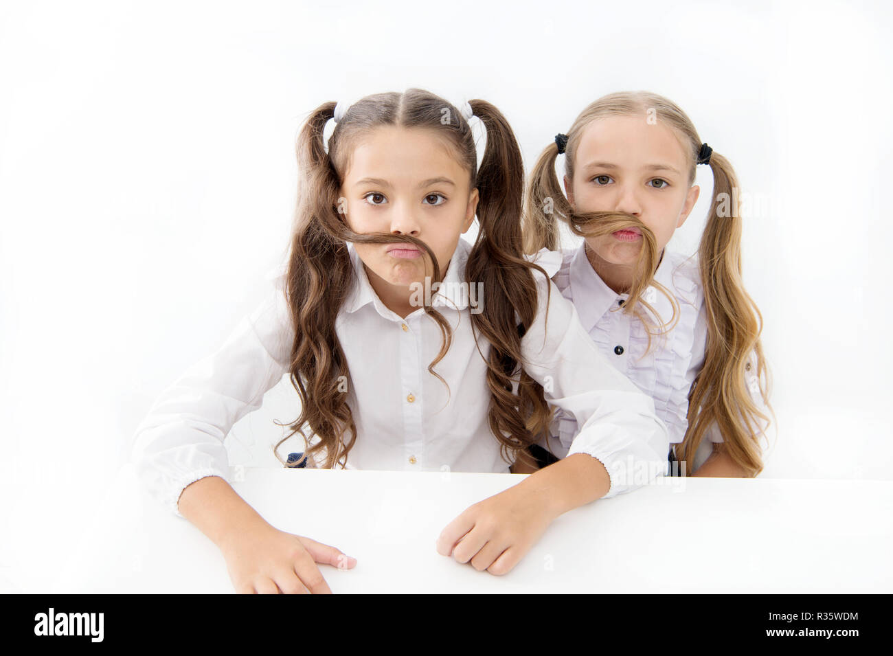 Girls make mustache with long hair white background. 