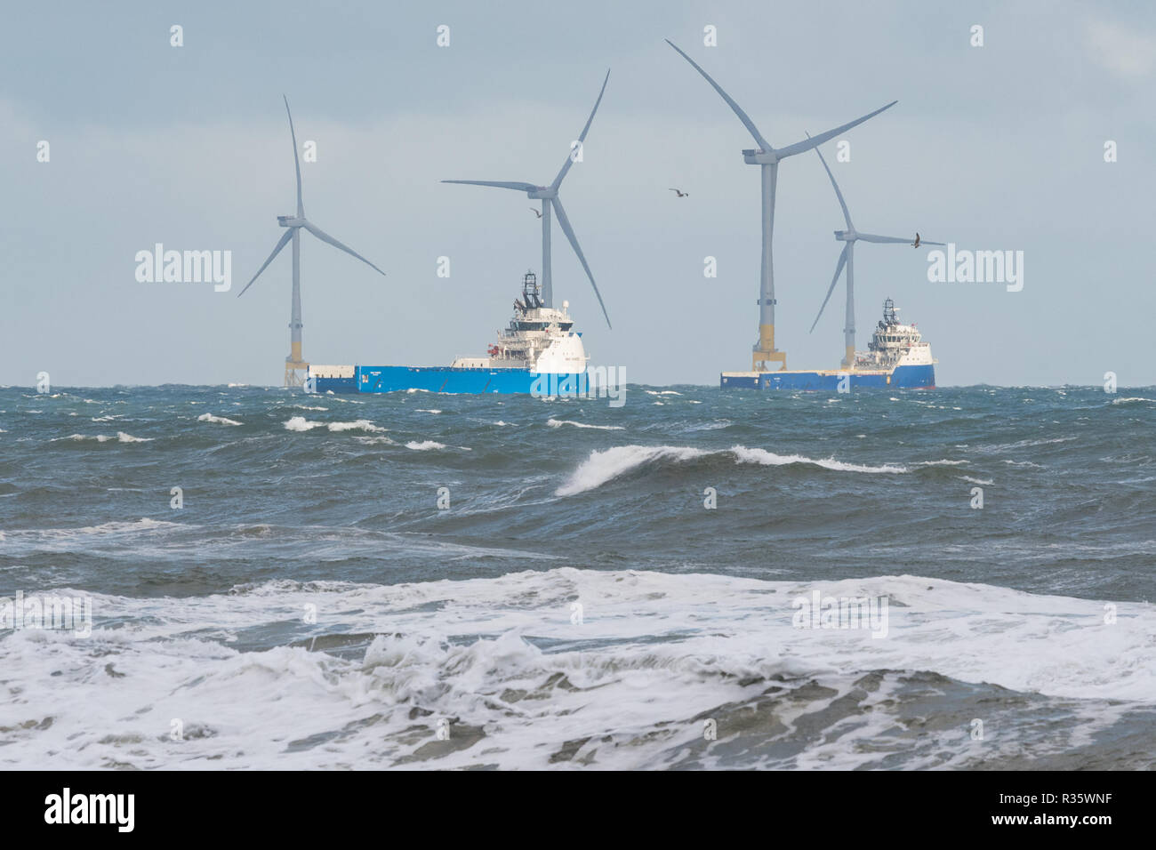 Aberdeen Offshore Wind Farm - European Offshore Wind Deployment Centre - and offshore supply ships, Aberdeen, Scotland, UK Stock Photo
