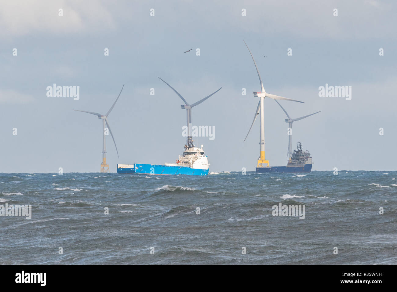 Aberdeen Offshore Wind Farm - European Offshore Wind Deployment Centre - and offshore supply ships, Aberdeen, Scotland, UK Stock Photo