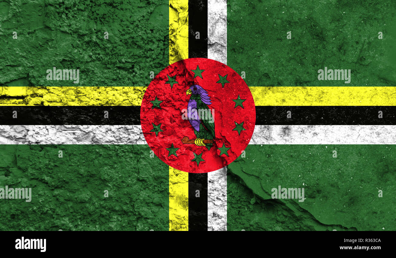 Flag of Dominica close up painted on a cracked wall, concept of armed ...