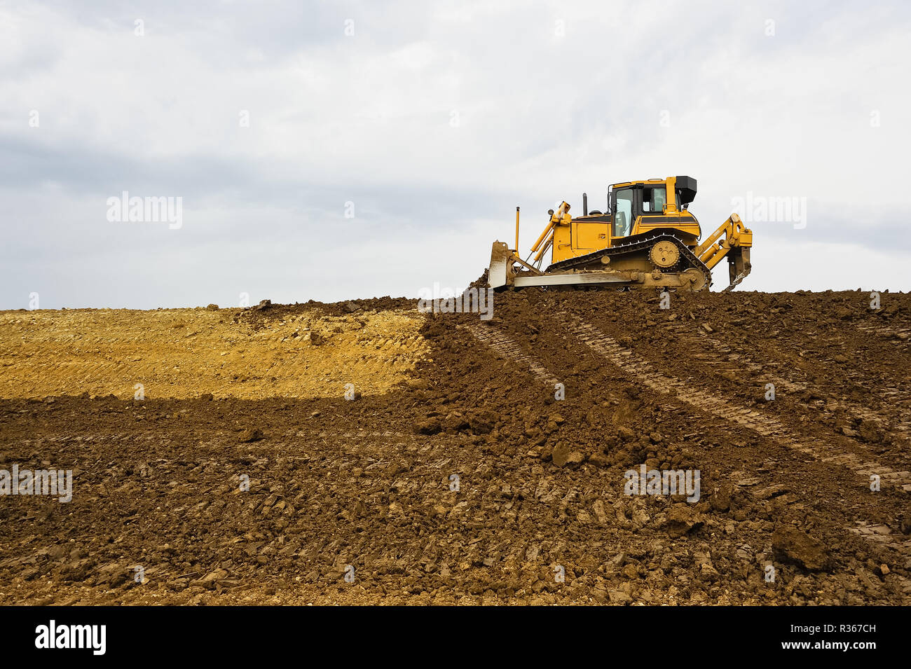 bulldozer is moving earth on construction site Stock Photo