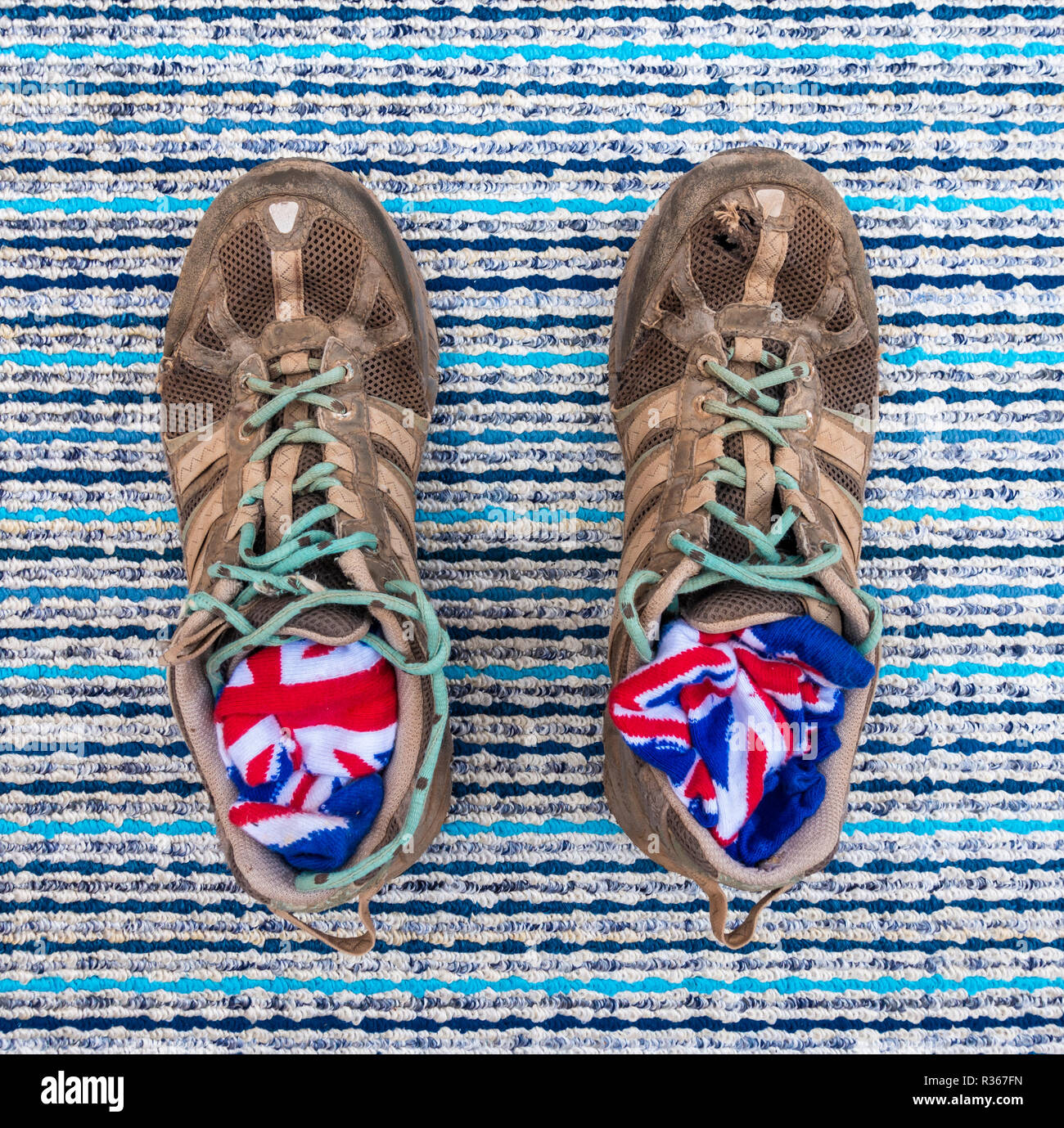 Well worn trainers and union jack socks on textured background Stock Photo