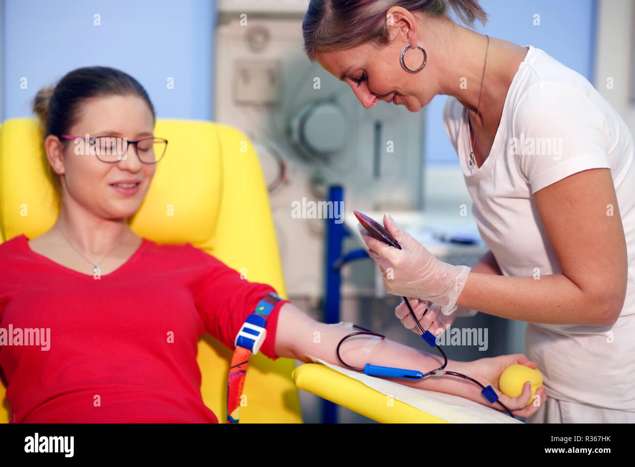 The nurse is taking blood from the patient at the hospital's