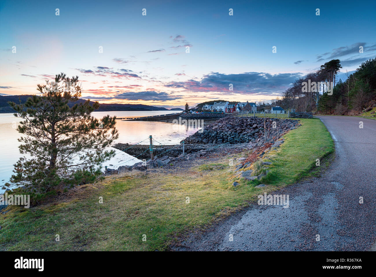 Dusk over the harbour at Shieldaig a pretty village in the Highlands of Scotland and a stop over on the NC500 driving route Stock Photo