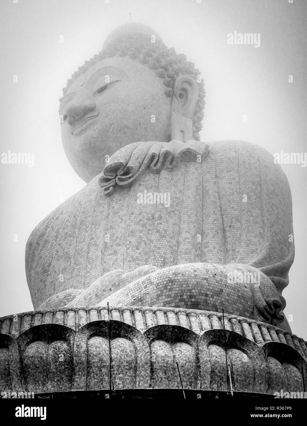 Beautiful Buddha statue between the clouds high up in a mountain. Big Buddha temple in Phuket. Gorgeous temples in Asia. Stock Photo