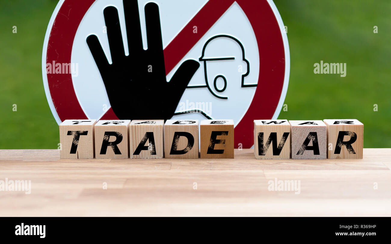 Dices form the words 'TRADE WAR' infront of a stop sign Stock Photo