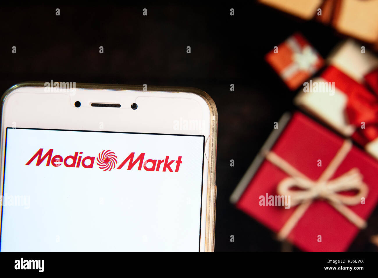 German electronics multinational chain of stores Media Markt logo is seen  on an Android mobile device with a Christmas wrapped gifts in the  background Stock Photo - Alamy