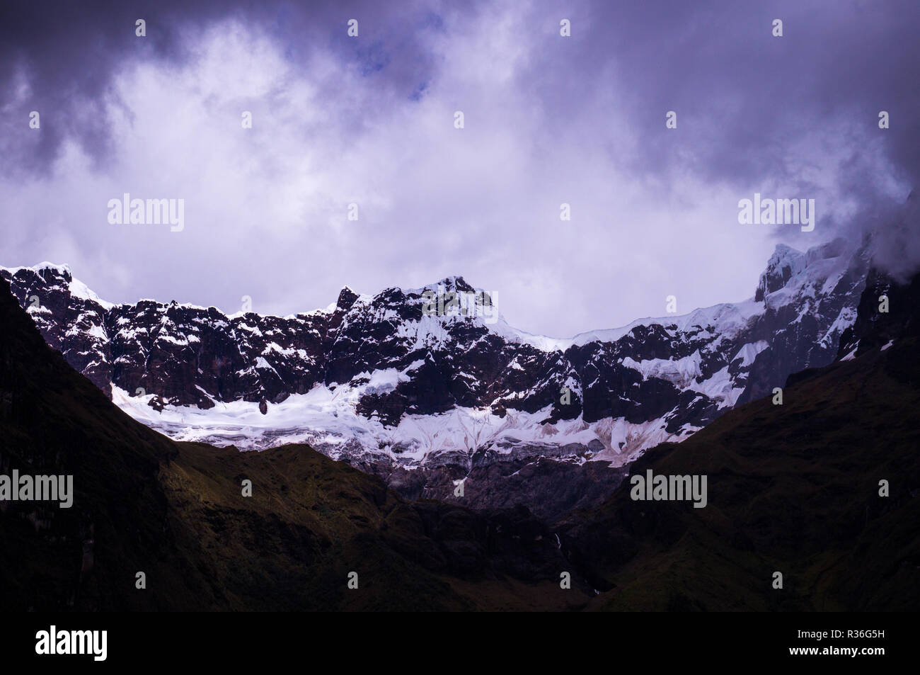 Snow covers the glacier at El Altar Volcano in the Andes near Banos, Ecuador. The Andean landscape near Banos in Ecuador features volcanic glaciers an Stock Photo