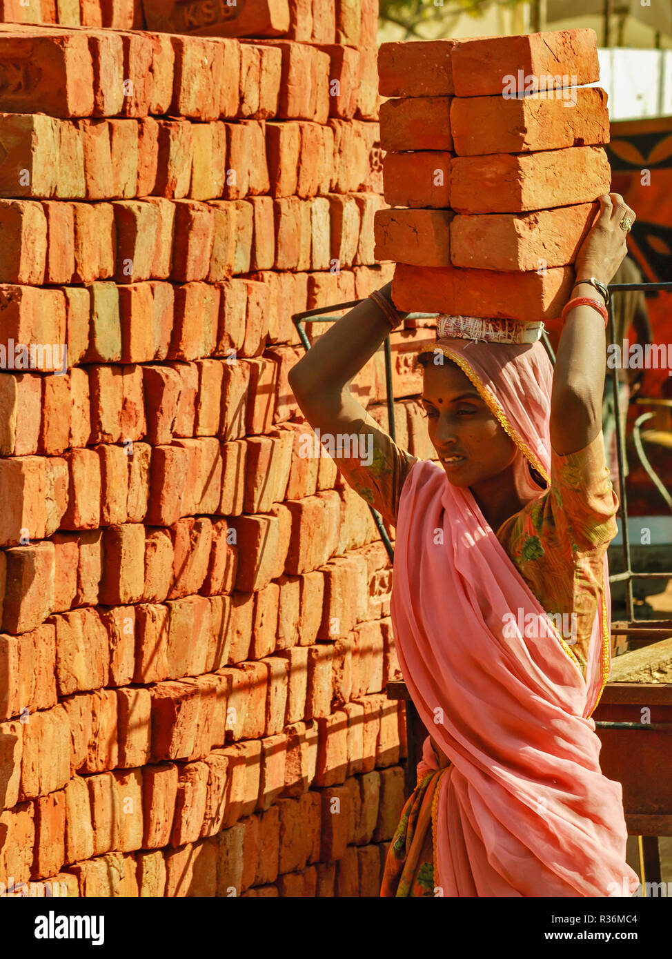 Carrying bricks on head hires stock photography and images Alamy