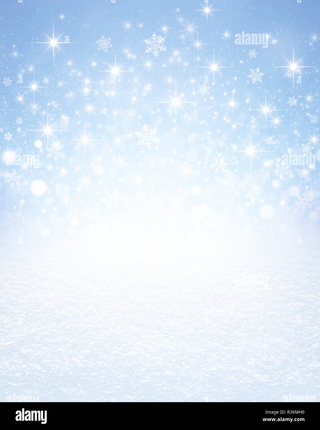 Snowflakes shapes and bright stars exploding on an icy blue background and white snow covered ground. Festive seasonal material. Stock Photo