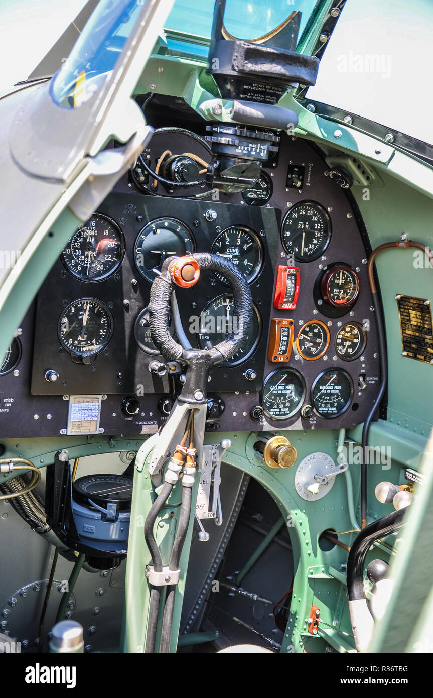 Second World War Supermarine Spitfire cockpit. Instrument panel, control  column, gun firing button, trigger. Dials, gauges. Gun sight. Spade grip  Stock Photo - Alamy