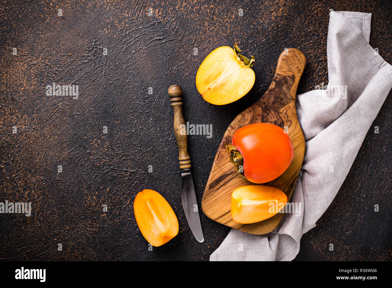 Fresh ripe persimmon on cutting board Stock Photo