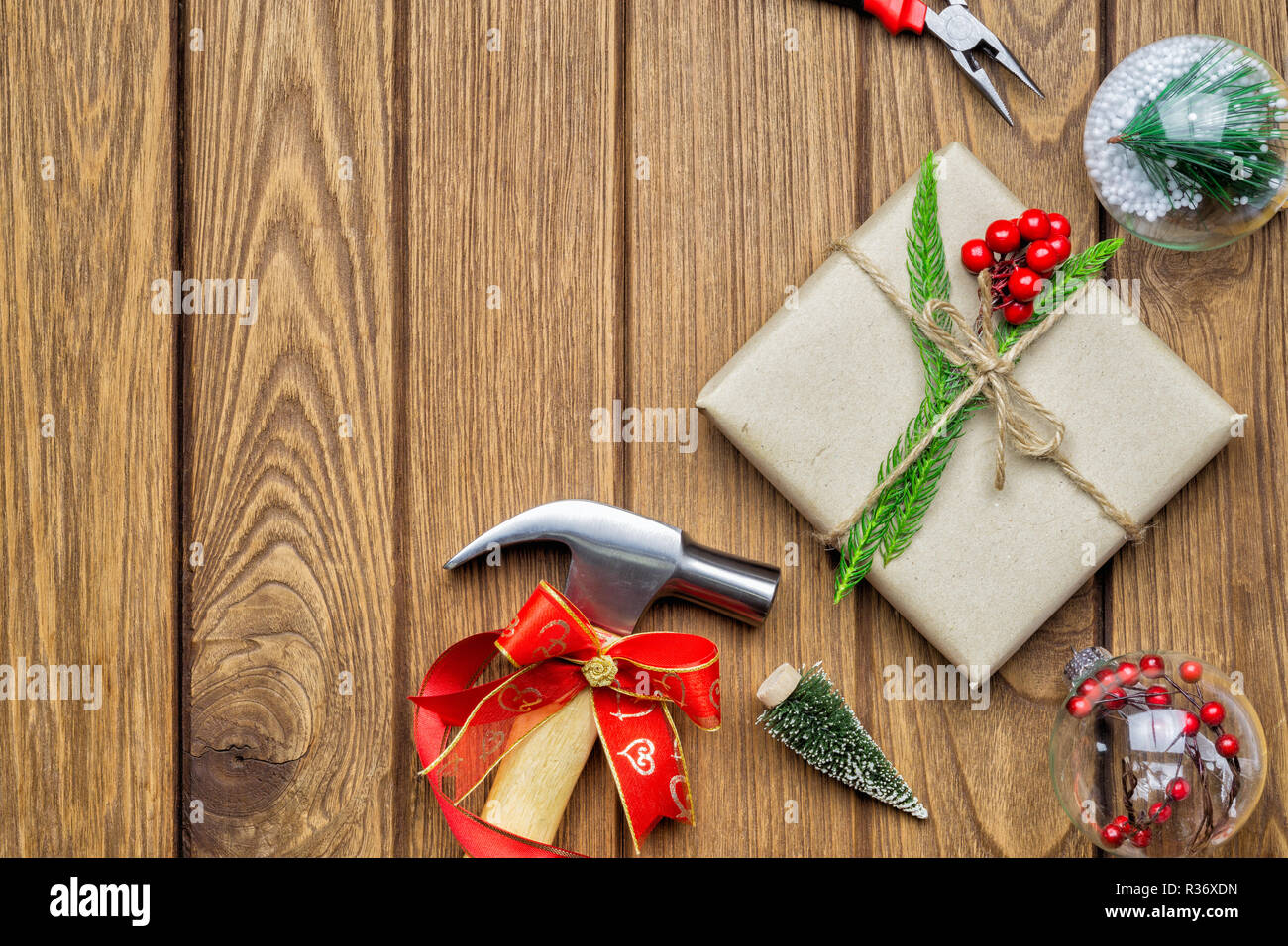 Merry Christmas Handy Tools Christmas Gift Concept Hammer Pliers Gift Box And Christmas Ornament Decorations On Wood Background Top View With Copy Stock Photo Alamy