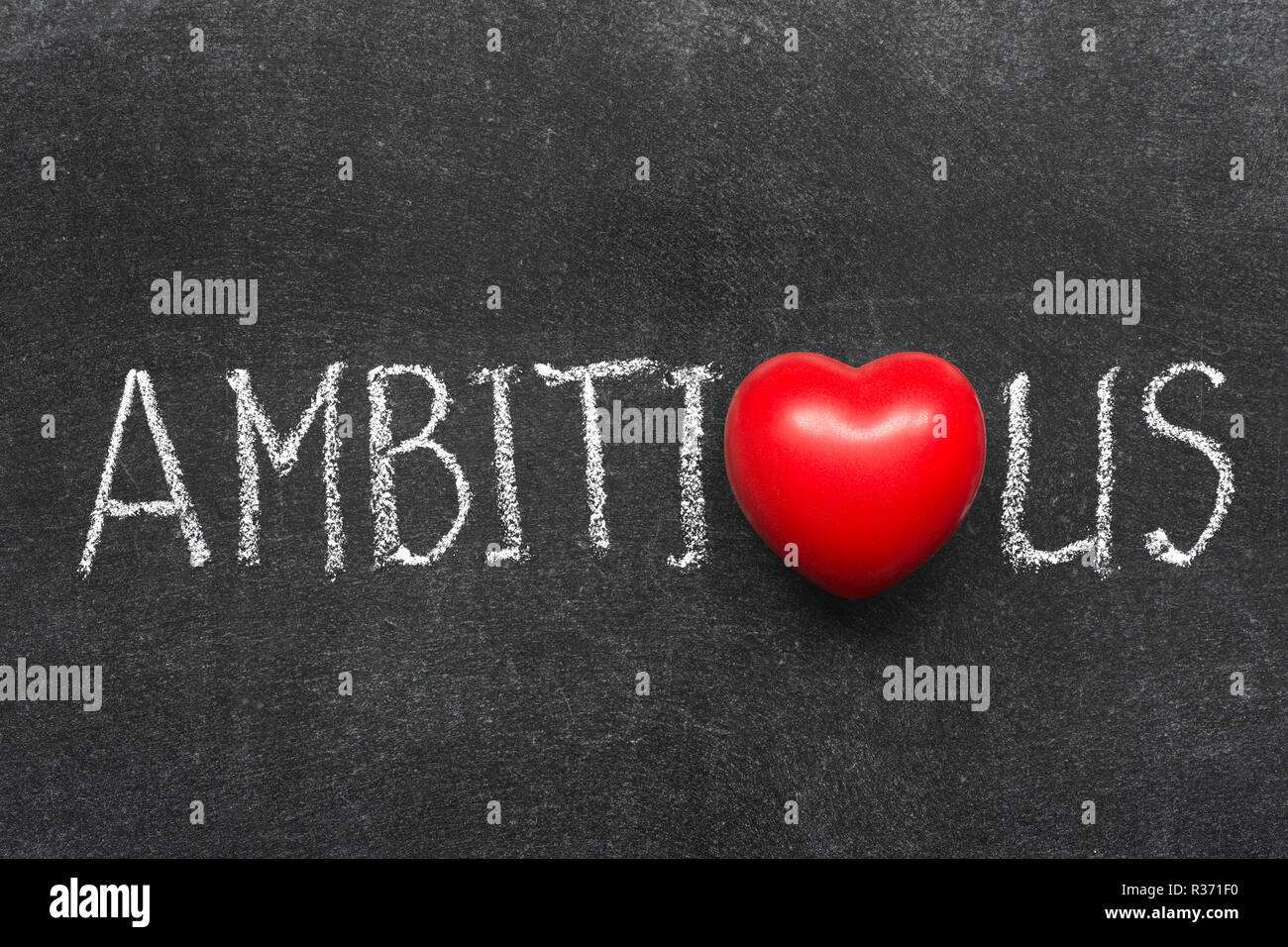 ambitious word handwritten on blackboard with heart symbol instead of O Stock Photo