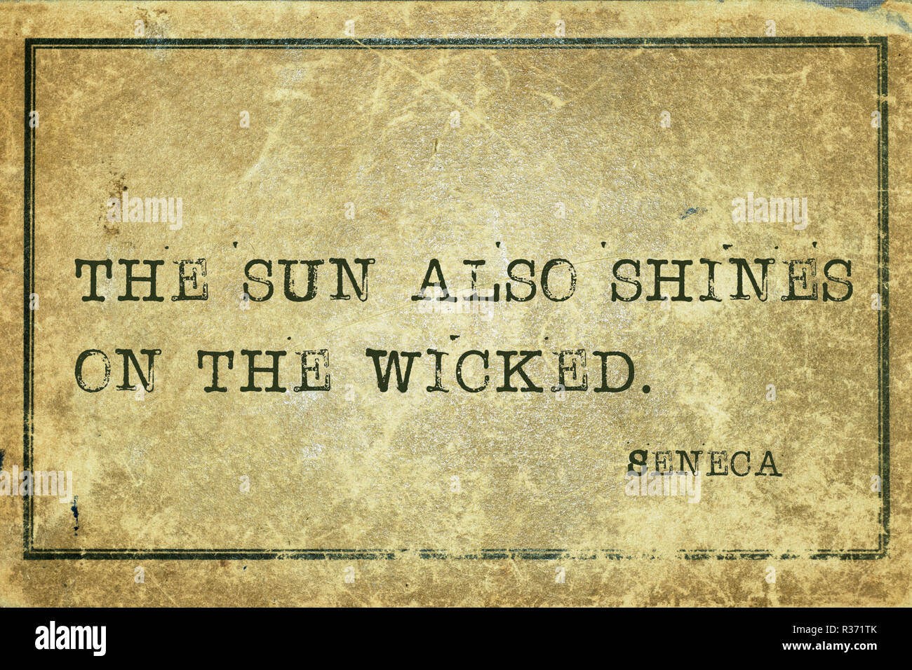 The sun also shines on the wicked - ancient Roman philosopher Seneca quote printed on grunge vintage cardboard Stock Photo