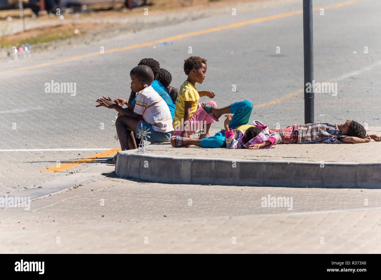street kids or street children working by selling souvenirs on the side of the road in South Africa Stock Photo