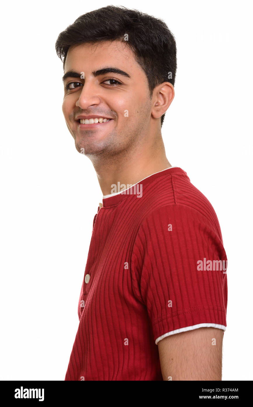 Young happy Persian man smiling and looking at camera Stock Photo
