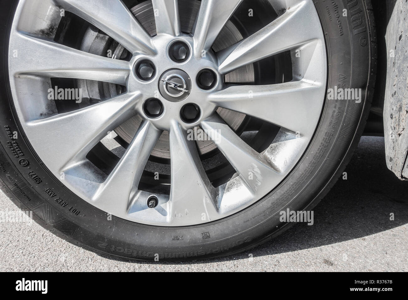 Scuffed/damaged wheel trim on hire car in Spain. Wheel damage is not covered with basic car hire insurance. Stock Photo