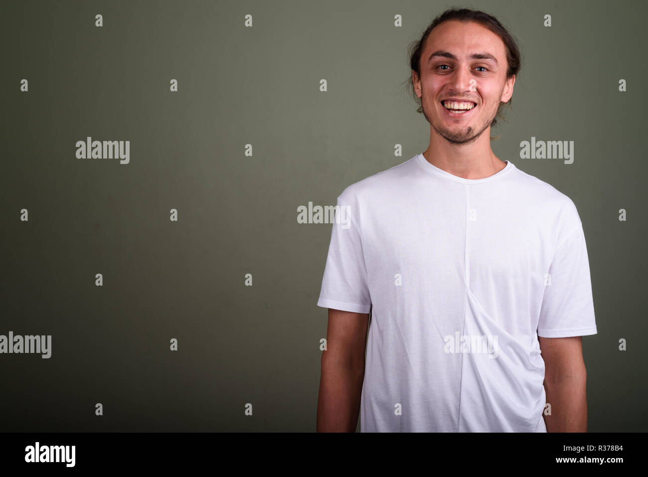 Young handsome man wearing white shirt against colored backgroun Stock Photo