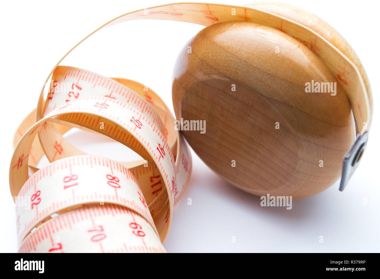 Yoyo effect in diet concept. Wooden yoyo with centimeter measure