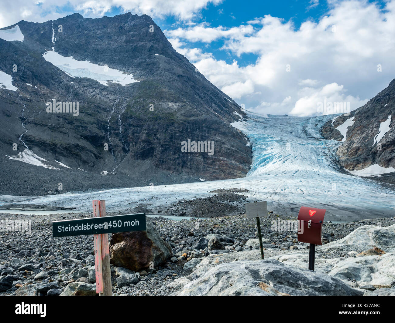Glacier Steindalsbreen, glacier tongue, signpost and 'trimkassa' at end of  valley Steindalen, Lyngen alps, south of Lyngseidet, Troms county, Norway Stock Photo