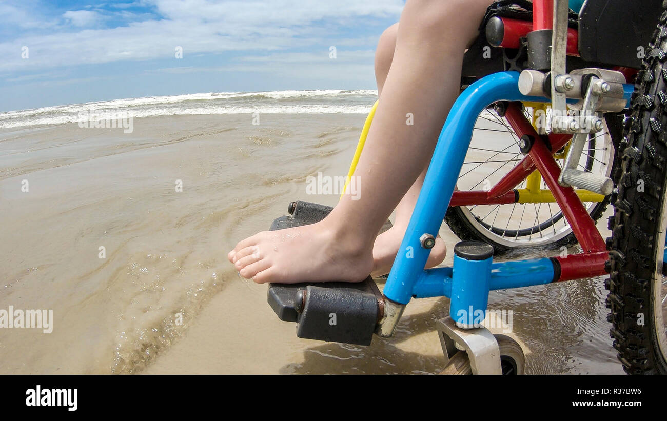 childlike wheelchair horizon sand Stock Photo