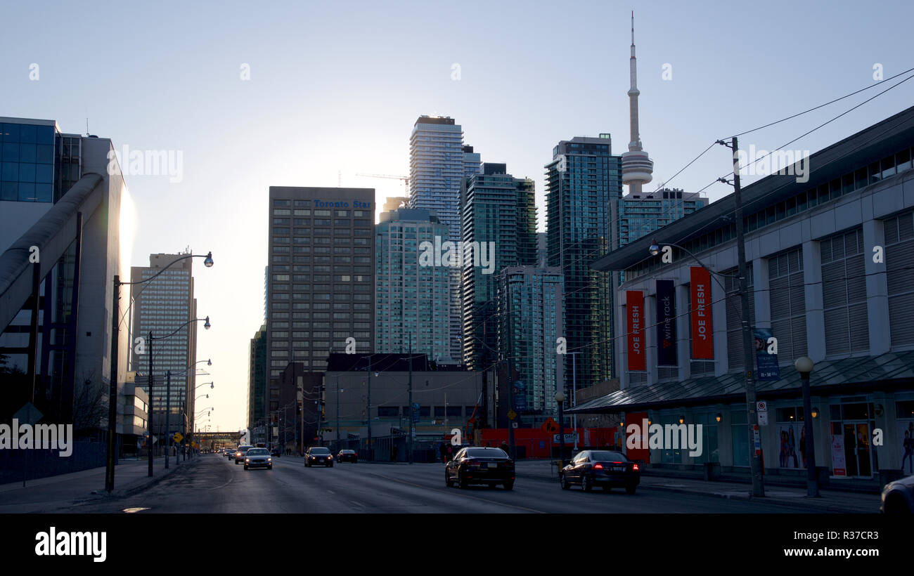 Downtown traffic in a busy street with cityscape background Stock Photo