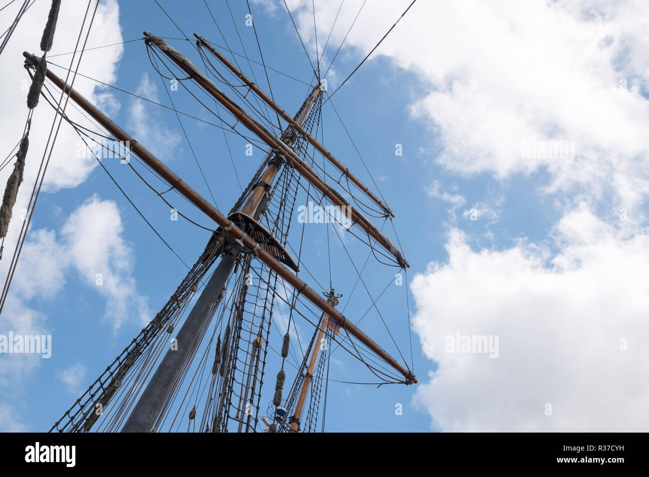 mast and rigging of an historic sailing ship against the blue sky with ...