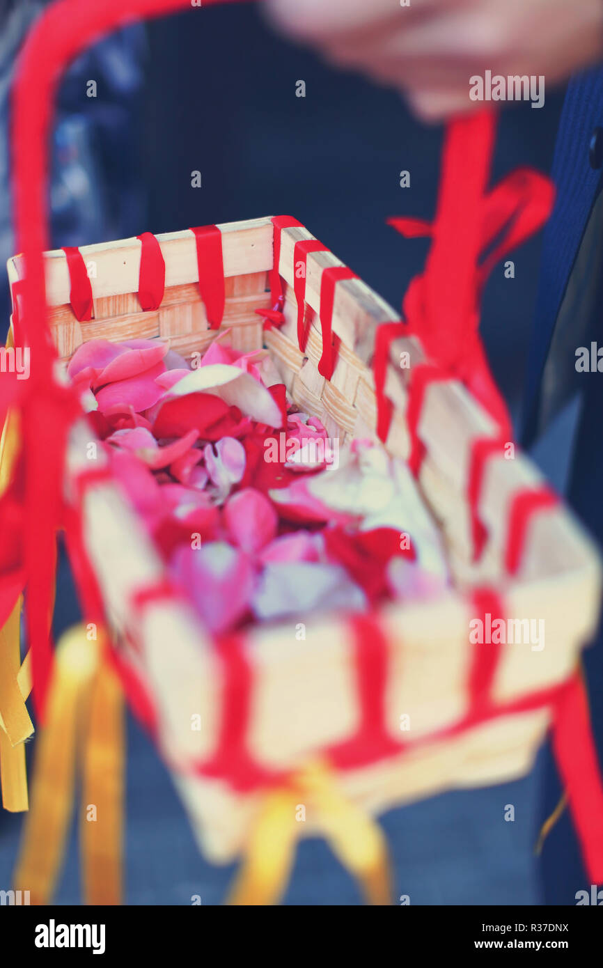 Beautiful wedding basket with colorful confetti, flower petals and ribbons Stock Photo Alamy