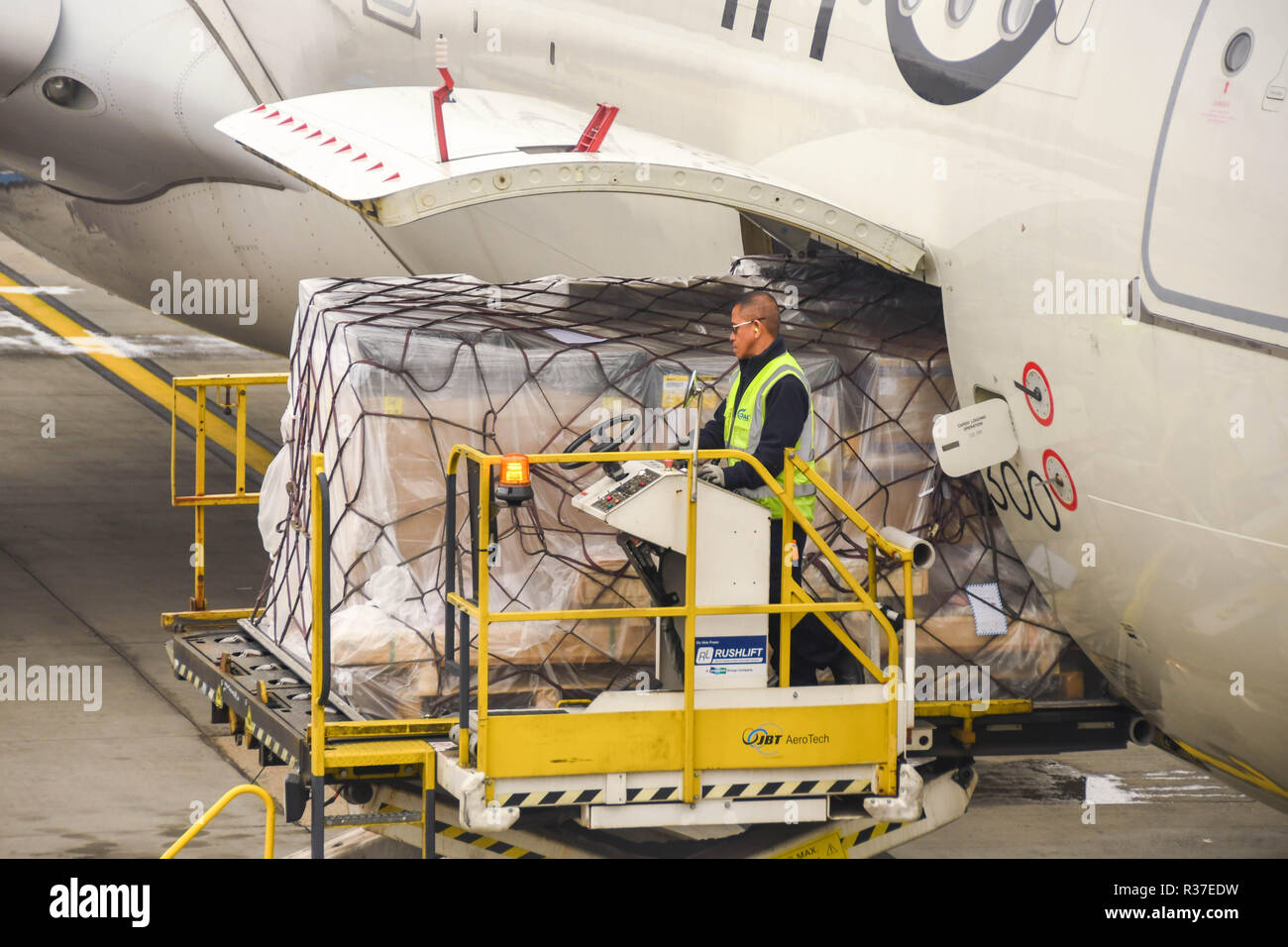 LONDON HEATHROW AIRPORT - JUNE 2018: Close up of an air freight pallet being loaded into the cargo hold of a Virgin Atlantic Airbus A330 at London Stock Photo