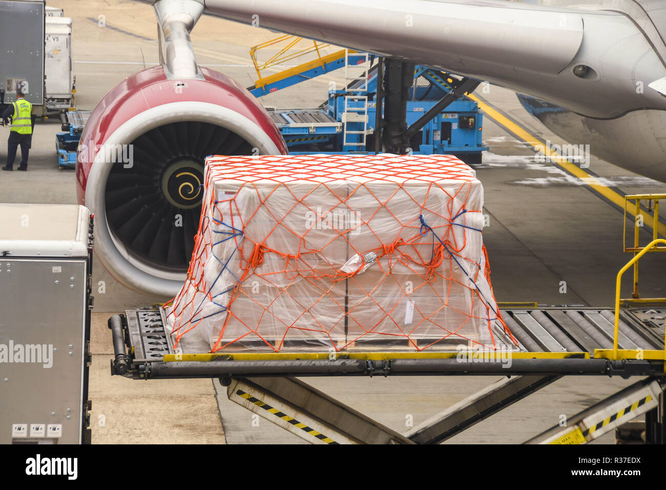 LONDON HEATHROW AIRPORT - JUNE 2018: Air freight  pallet wrapped in plastic being loaded into the hold of a Virgin Atlantic Airbus A330 at London Stock Photo