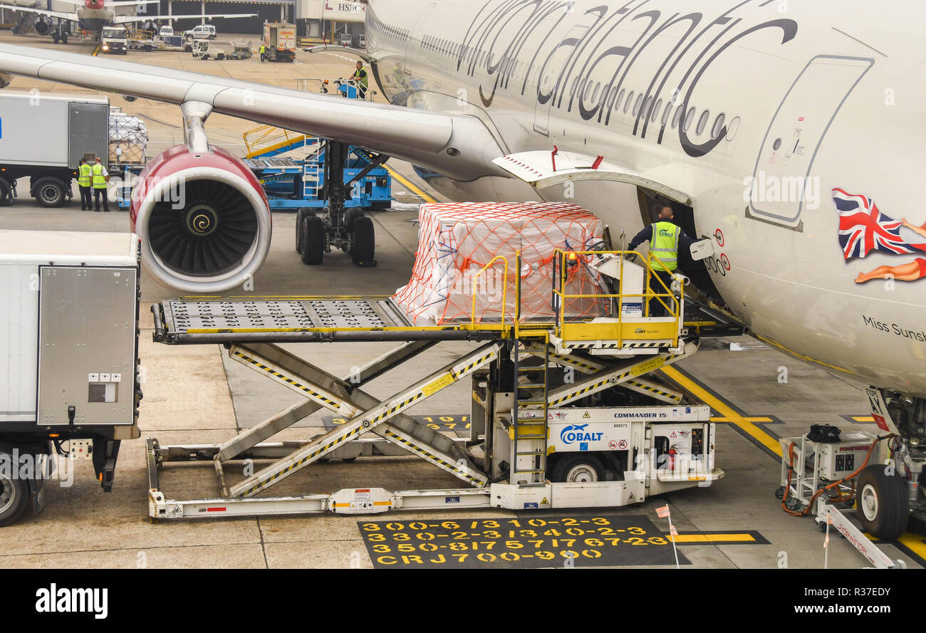 LONDON HEATHROW AIRPORT - JUNE 2018: Air freight pallet being loaded into the cargo hold of a Virgin Atlantic Airbus A330 at London Heathrow Airport. Stock Photo