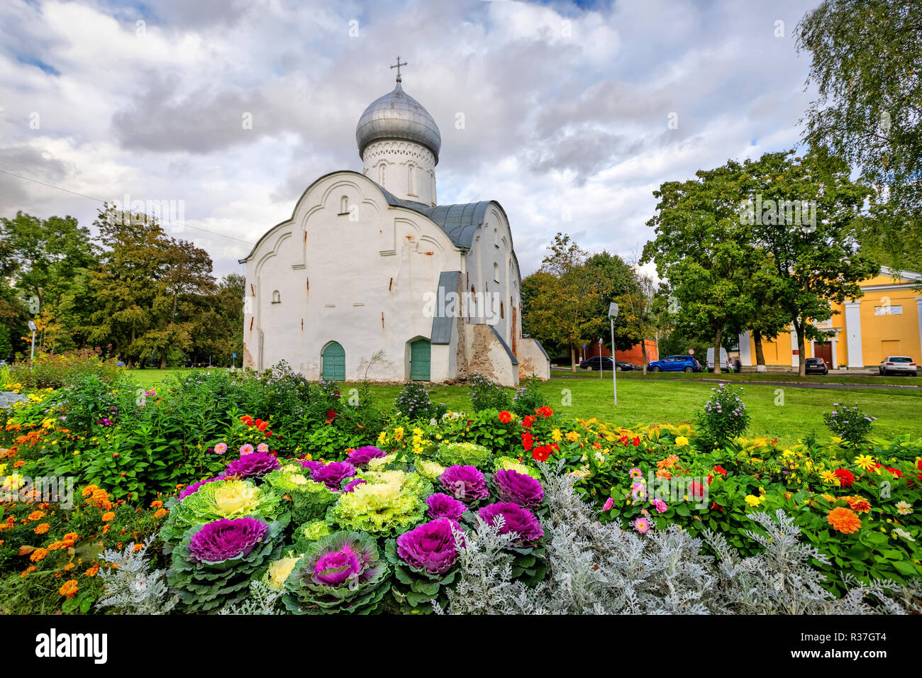 Historic Blasius Church built in 1407 with colorful flowerbed on foreground in Veliky Novgorod, Russia Stock Photo
