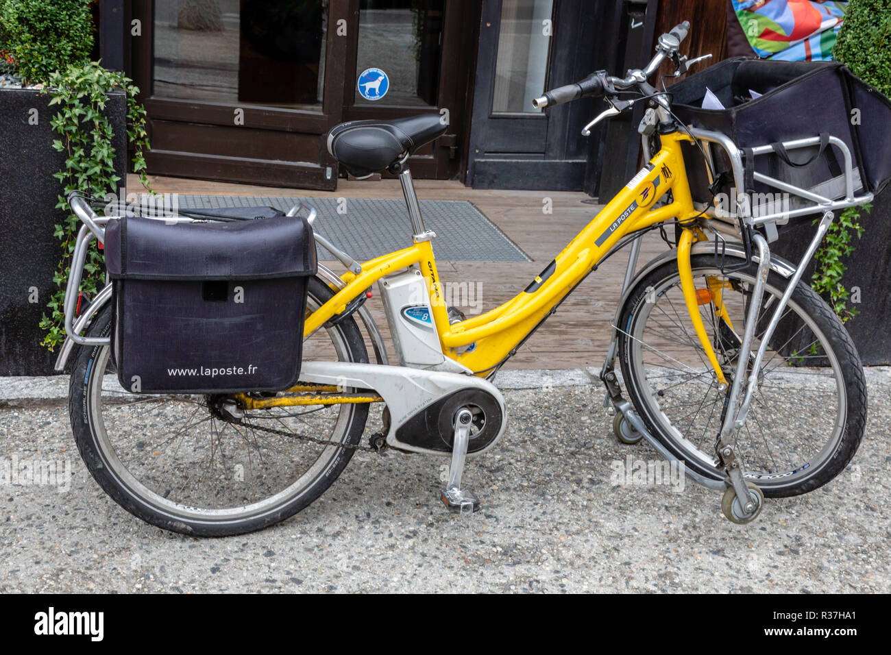 Yellow French postmans bike with panniers on its stand in front of a house  Stock Photo - Alamy